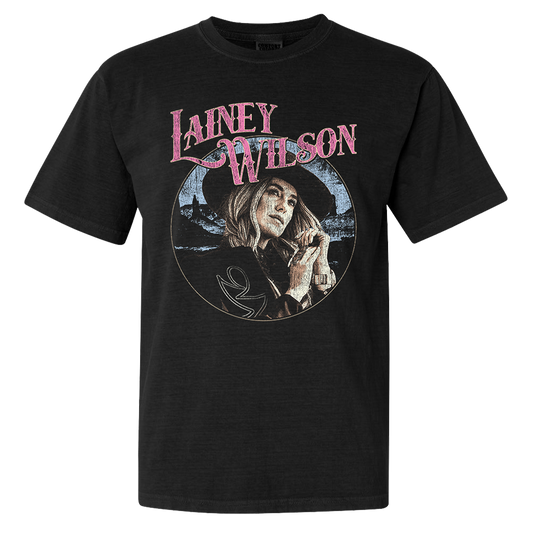 Official Lainey Wilson Merchandise. Black, 100% cotton heavy weight t-shirt with a full color desert photo of Lainey Wilson and a pink logo. 