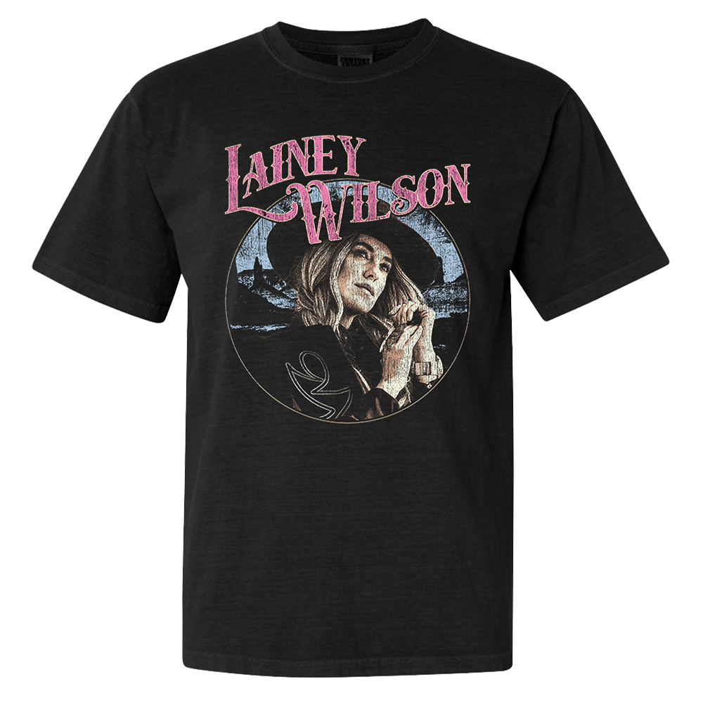 Official Lainey Wilson Merchandise. Black, 100% cotton heavy weight t-shirt with a full color desert photo of Lainey Wilson and a pink logo. 