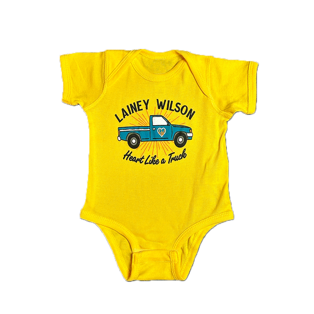 Yellow baby onesie with ’Lainey Wilson Heart Like a Truck’ text and a blue pickup truck graphic.