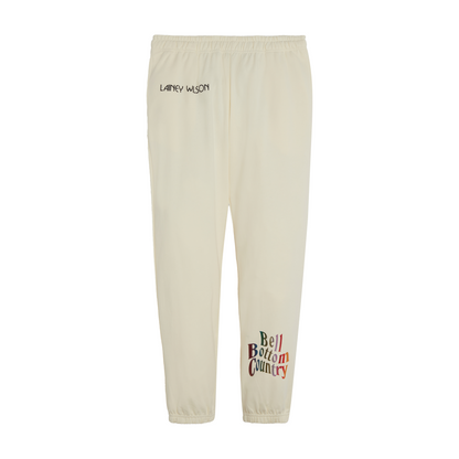 Cream-colored sweatpants with ’Lainey Wilson’ and ’Bell Bottom Country’ text printed on them.