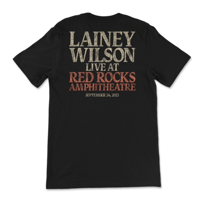 Black t-shirt with text advertising a Lainey Wilson concert at Red Rocks Amphitheatre on September 26, 2023.