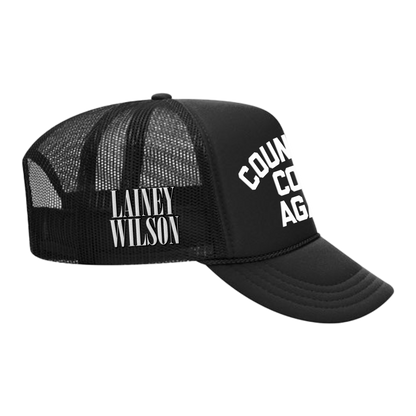 Black trucker-style cap with ’LAINEY WILSON’ and ’COUNTRY CO AGE’ text printed on it.