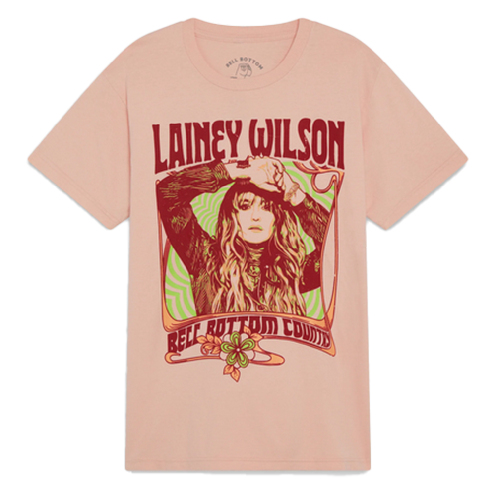 Pink t-shirt featuring a retro-style graphic design of a woman with long hair and the name ’Lainey Wilson’ in red text.